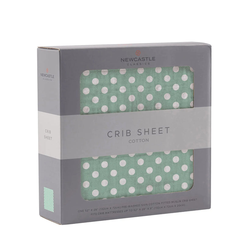 Jade polka dot cotton muslin crib sheet in packaging.