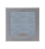 Blue fog cotton muslin crib sheet fitted on a standard crib mattress
