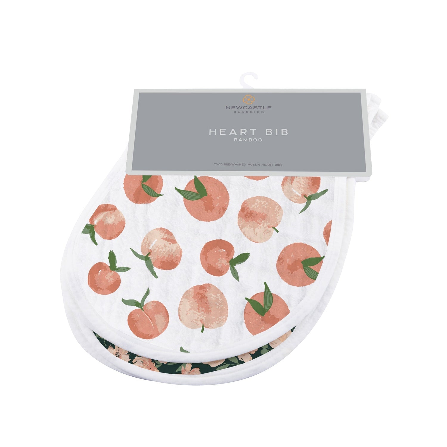 Two heart-shaped baby bibs in a warm Canyon Sunset print with snap closures at the neck