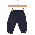 Baby pants in dark midnight blue with a moon and star pattern and an elastic waistband