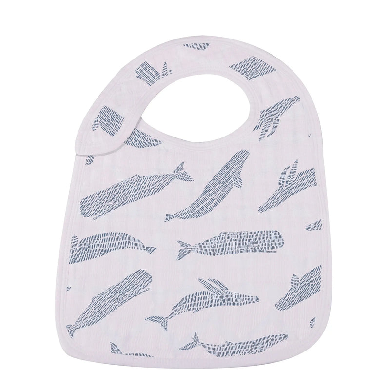 Ocean Tides Bamboo Snap Bib with whale design, made from 100% natural bamboo muslin, featuring front snaps for adjustable fit.