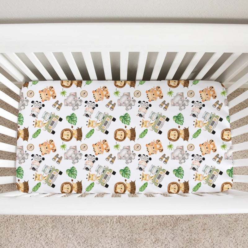 Fitted crib sheet with safari animal pattern in white crib.