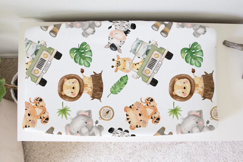Safari-themed changing pad cover with animal and jeep print, soft and stretchy for baby nursery.