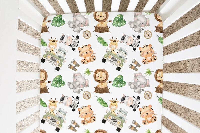 Fitted crib sheet with safari animal pattern in a crib.
