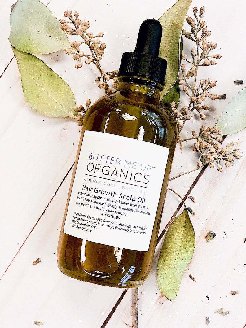 Organic Scalp Treatment in glass bottle with herbs and oils for hair growth and repair.