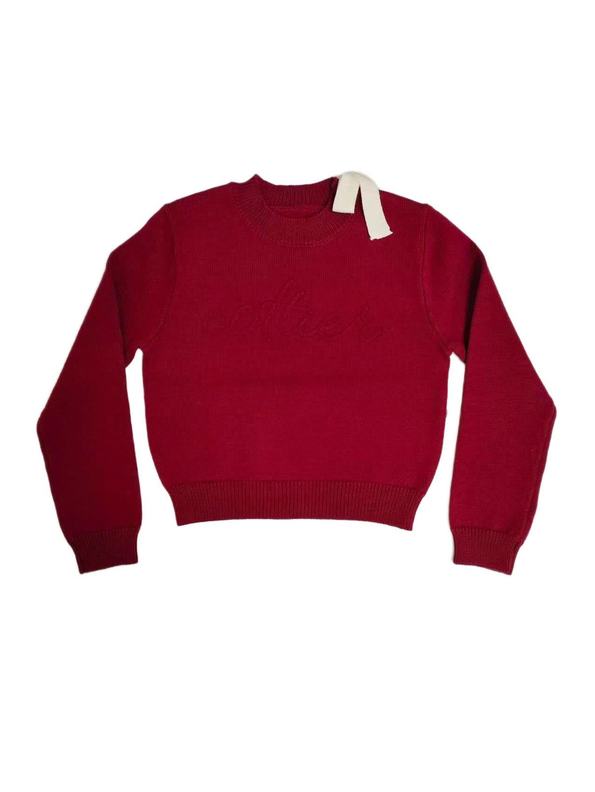 Crimson chunky knit top with a shoulder bow and "Cottier" lettering across the front