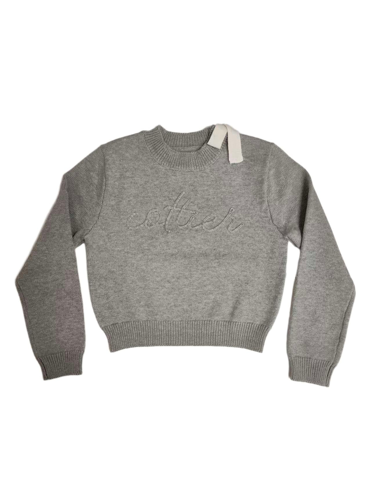 Grey chunky knit top with a shoulder bow and Cottier lettering