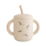Mushie silicone training cup with straw in a neutral color, perfect for baby-led weaning.
