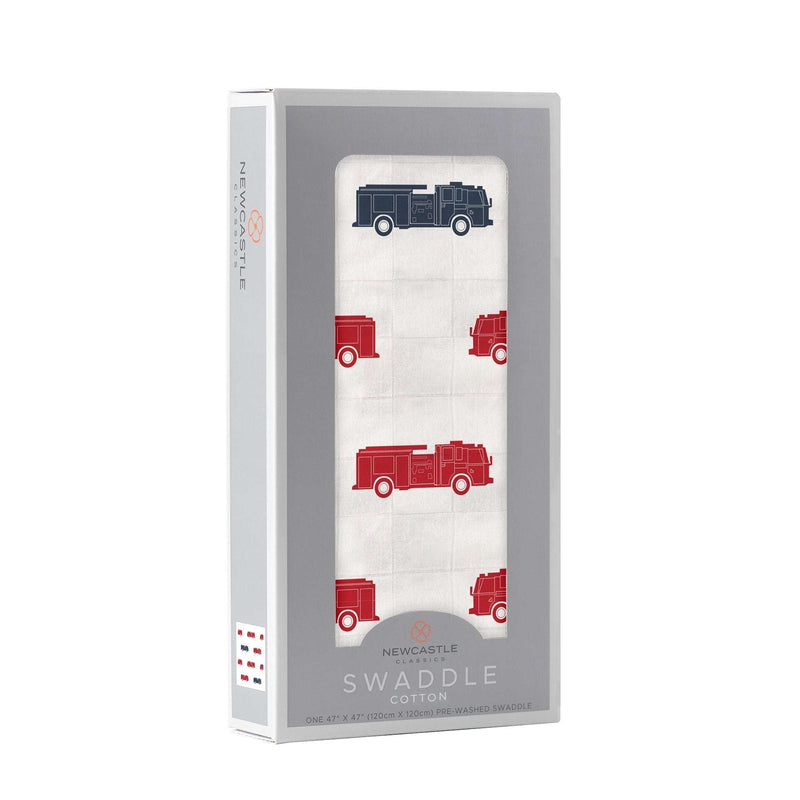 Blue and red fire trucks swaddle blanket in packaging, made from 100% natural cotton muslin.