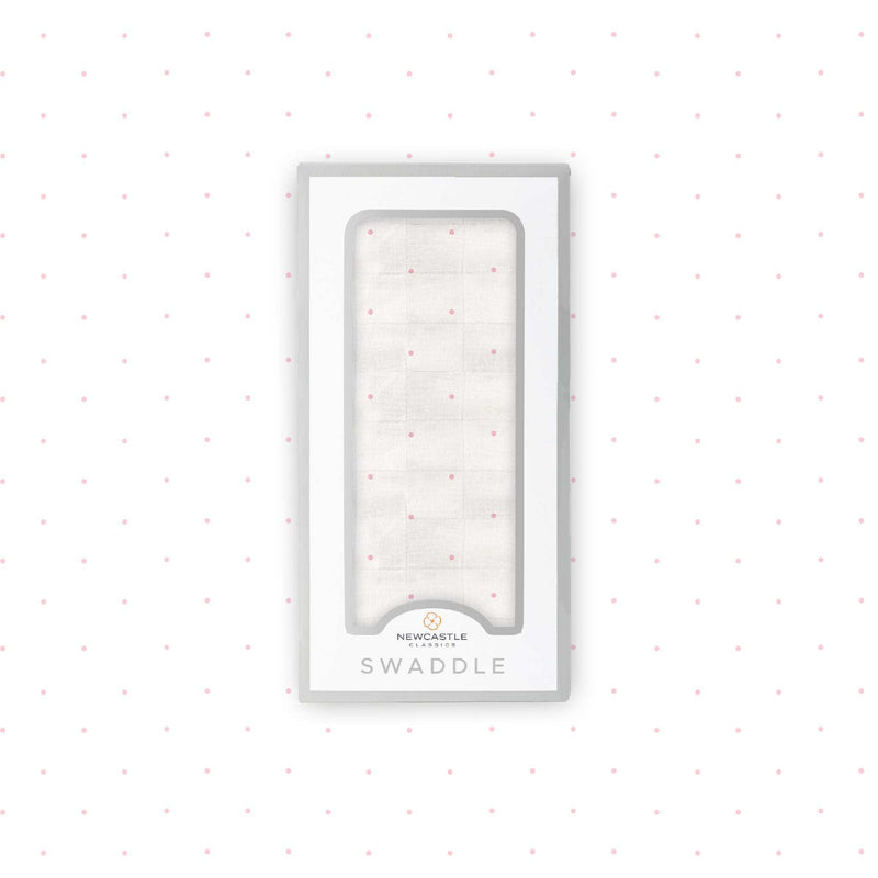 Pink polka dot bamboo muslin swaddle in packaging.