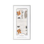 Cotton muslin swaddle blanket printed with foxes and forest friends in a repeating pattern