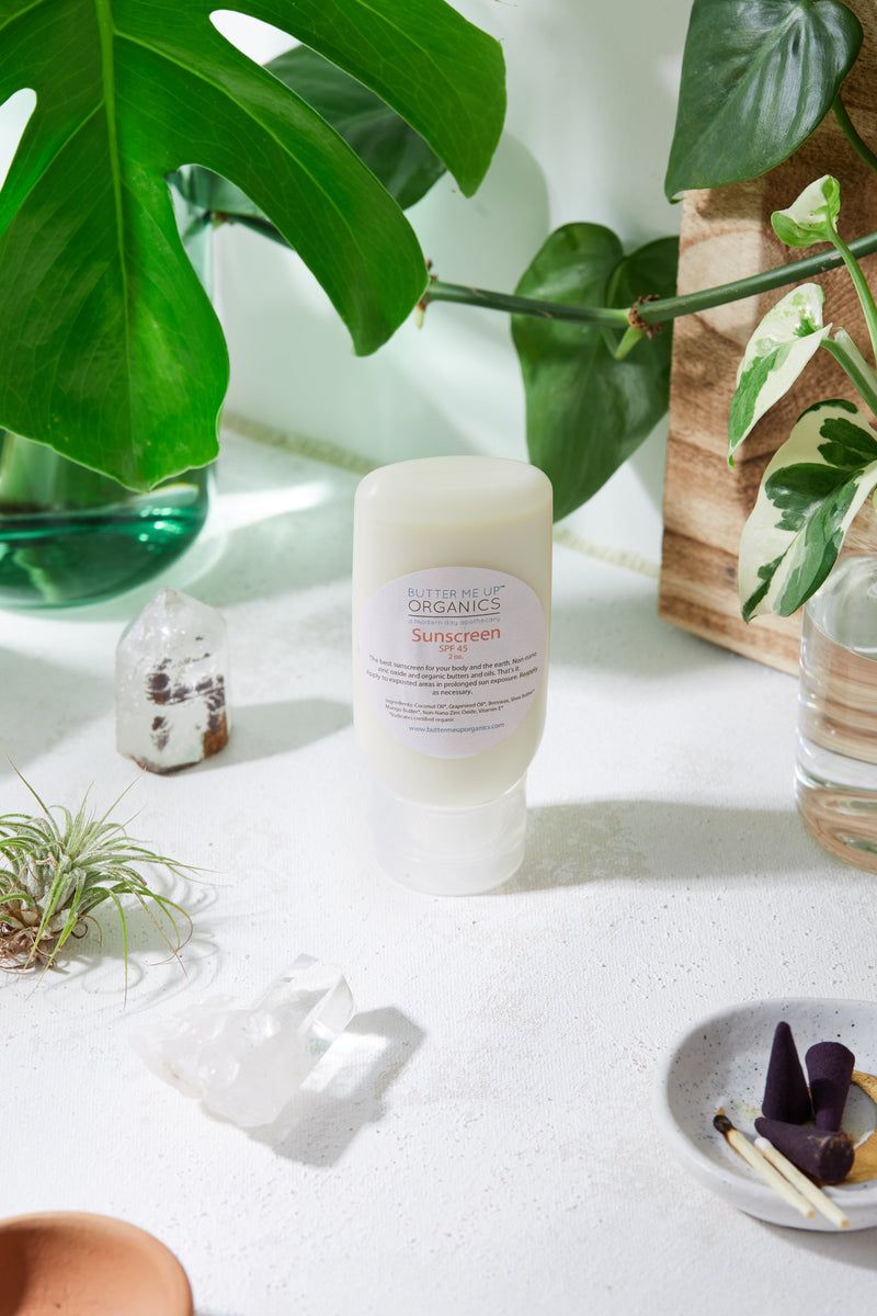 Natural organic sunscreen with non-nano zinc oxide SPF 45, eco-friendly packaging, surrounded by plants and crystals.