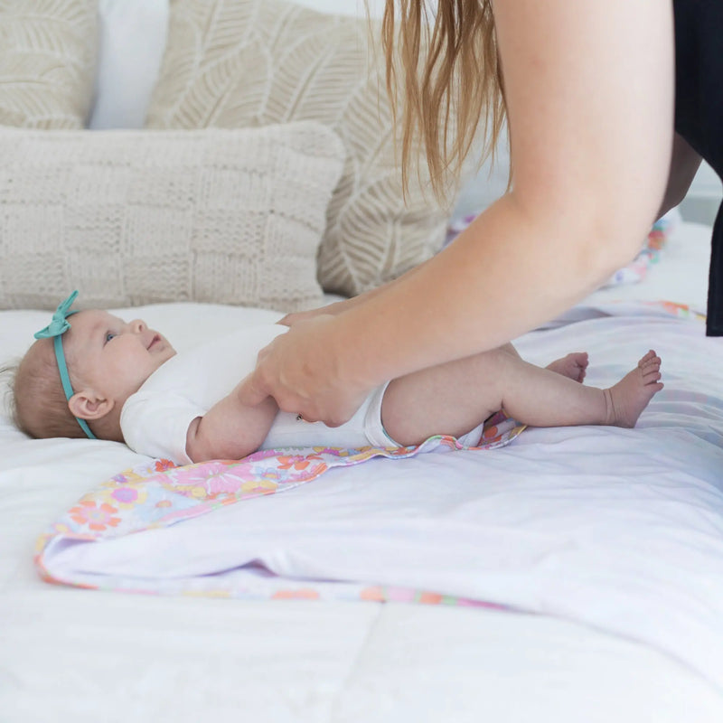 Buttery soft and stretchy swaddle blanket with retro floral design.