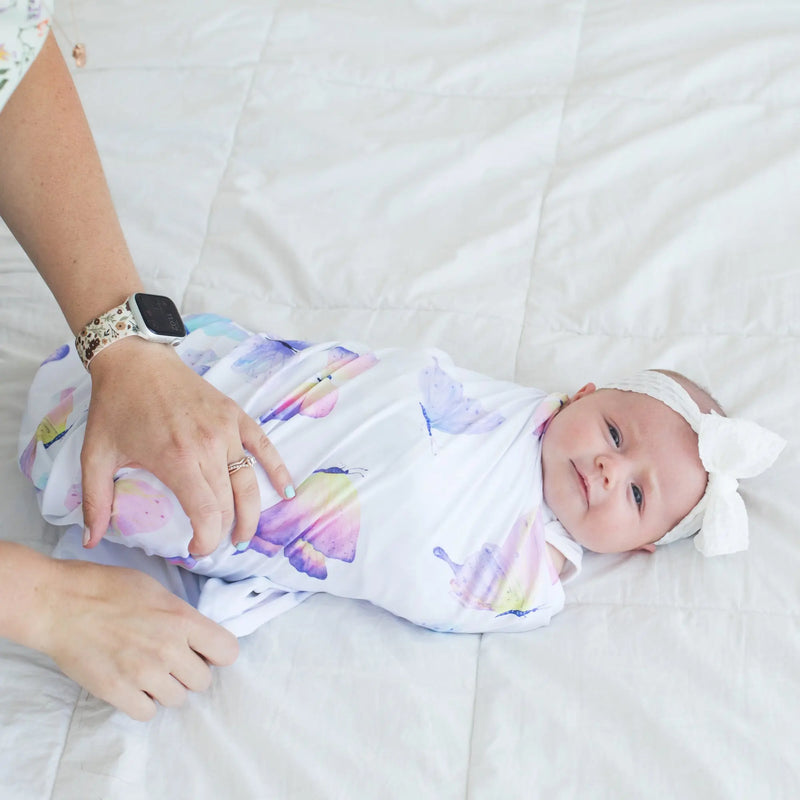 Buttery soft and stretchy butterfly swaddle blanket with baby.