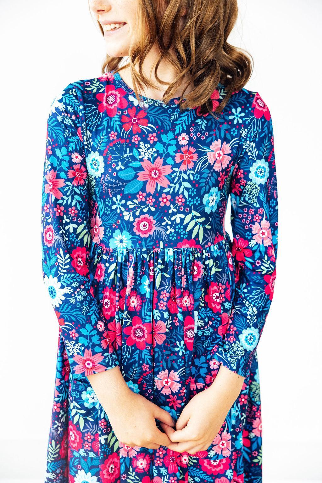 Long sleeve twirl dress with gardenia floral print, full-circle skirt, pocket, and scoop back neckline