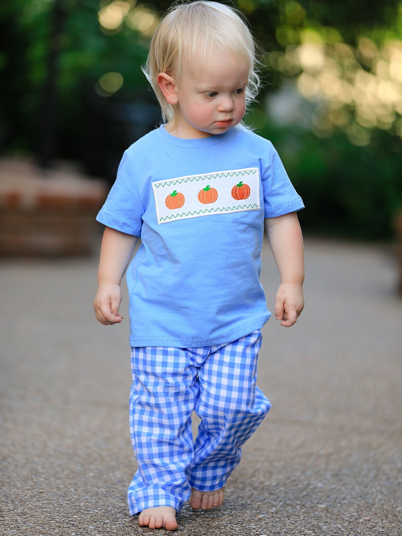Baby boy two-piece set with a smock featuring blue pumpkin embroidery for fall and Halloween.