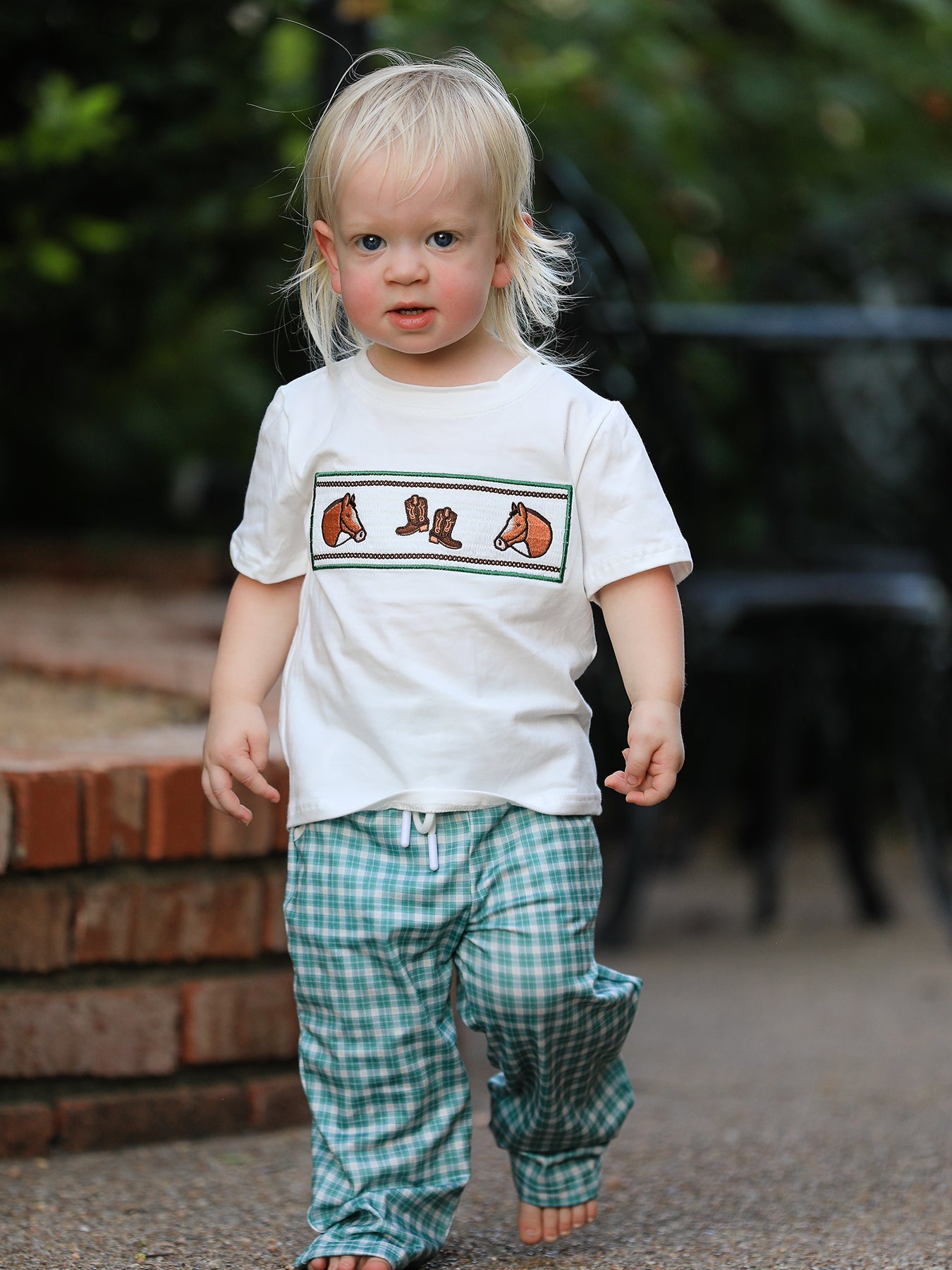 Two-piece boy set: white tee with horse and cowboy boot embroidery and mint plaid drawstring pants.