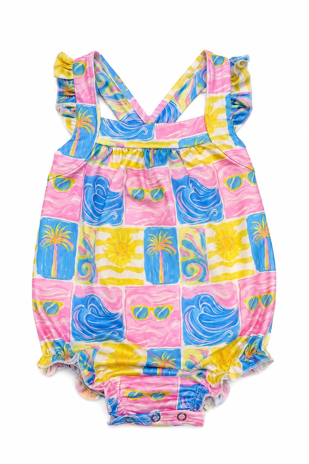 Ruffle cross back romper in a tropical summer print with criss-cross back straps and a shoulder ruffle