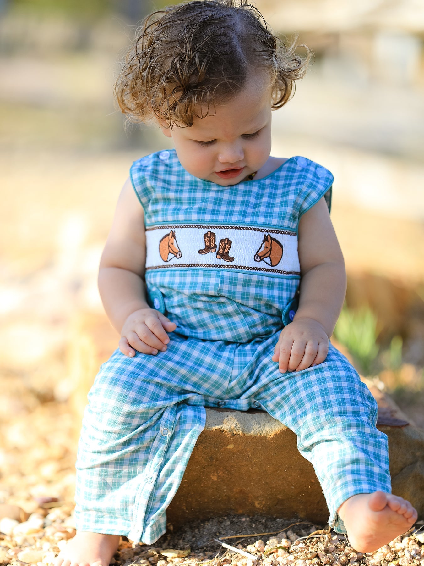 Sleeveless mint plaid baby boy JonJon romper with horse and cowboy boot embroidery on the chest and button shoulders.