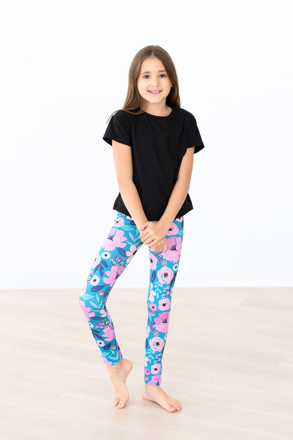 Mila & Rose Twirling in Teal organic baby leggings.