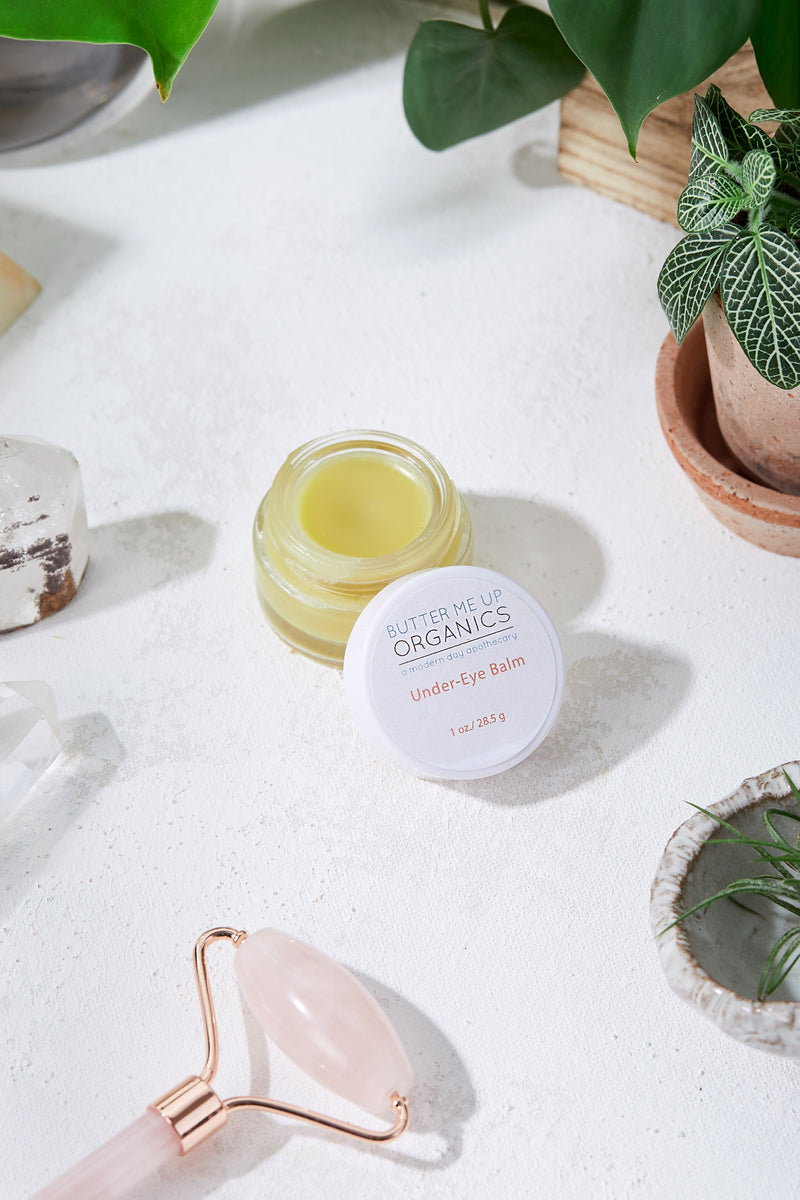 Caffeinated under-eye balm in glass jar for dark circles and puffiness.