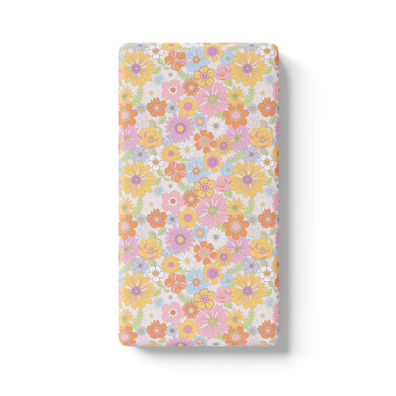 Retro floral fitted crib sheet with colorful flower pattern.