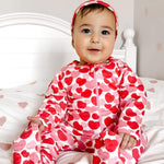 Norani Baby organic cotton footie pajamas with red and pink hearts.