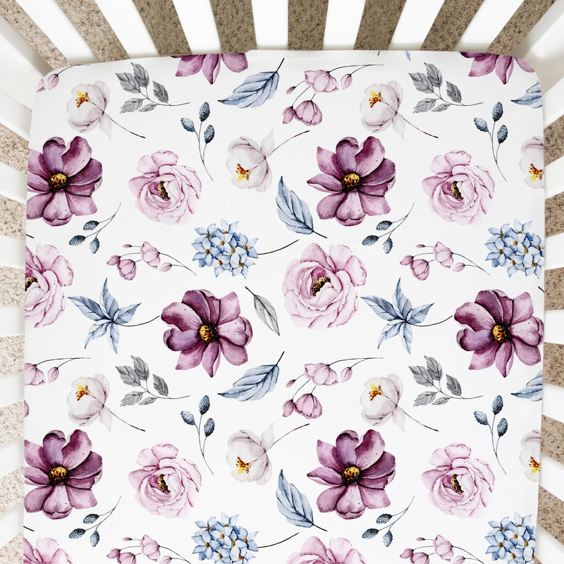 Vintage floral fitted crib sheet in a crib with soft, unique patterns.