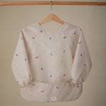 Mushie Water Resistant Long Sleeve Bib for Kids with Wide Pocket and Velcro Closure - Baby & Toddler > Nursing & Feeding > Bibs Long Sleeve Bib