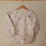 Mushie Water Resistant Long Sleeve Bib for Kids with Wide Pocket and Velcro Closure - Baby & Toddler > Nursing & Feeding > Bibs Long Sleeve Bib