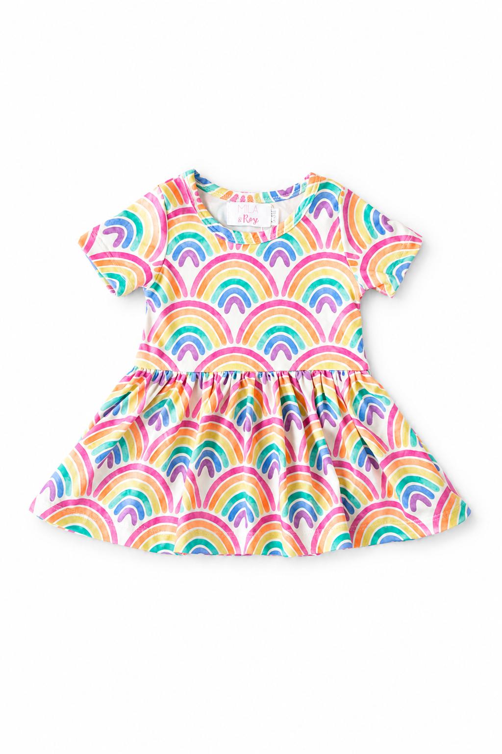 Short-sleeve baby twirl bodysuit with a watercolor rainbow print and attached twirl skirt