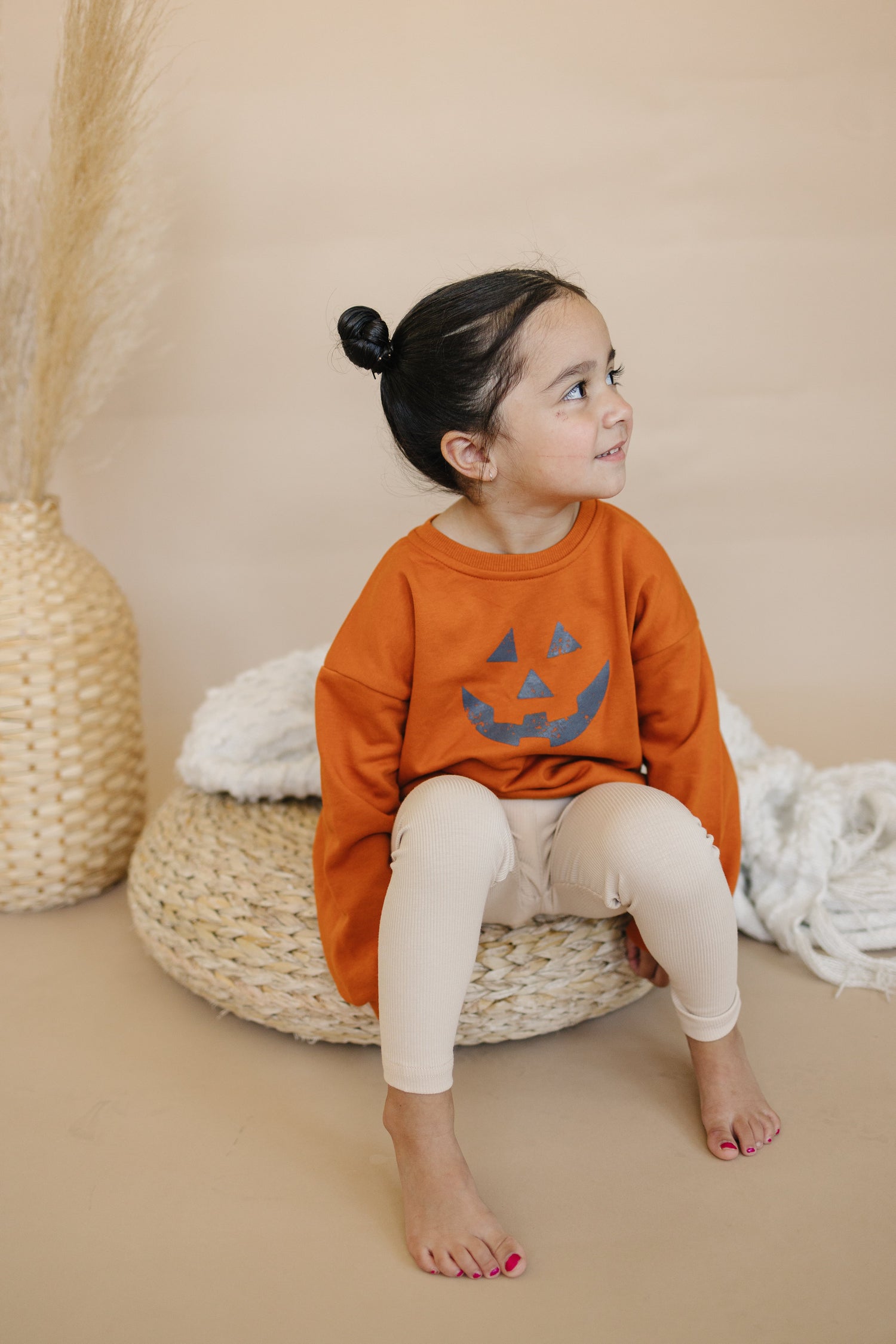 Oversized crewneck sweatshirt with a Jack O Lantern pumpkin graphic on the front