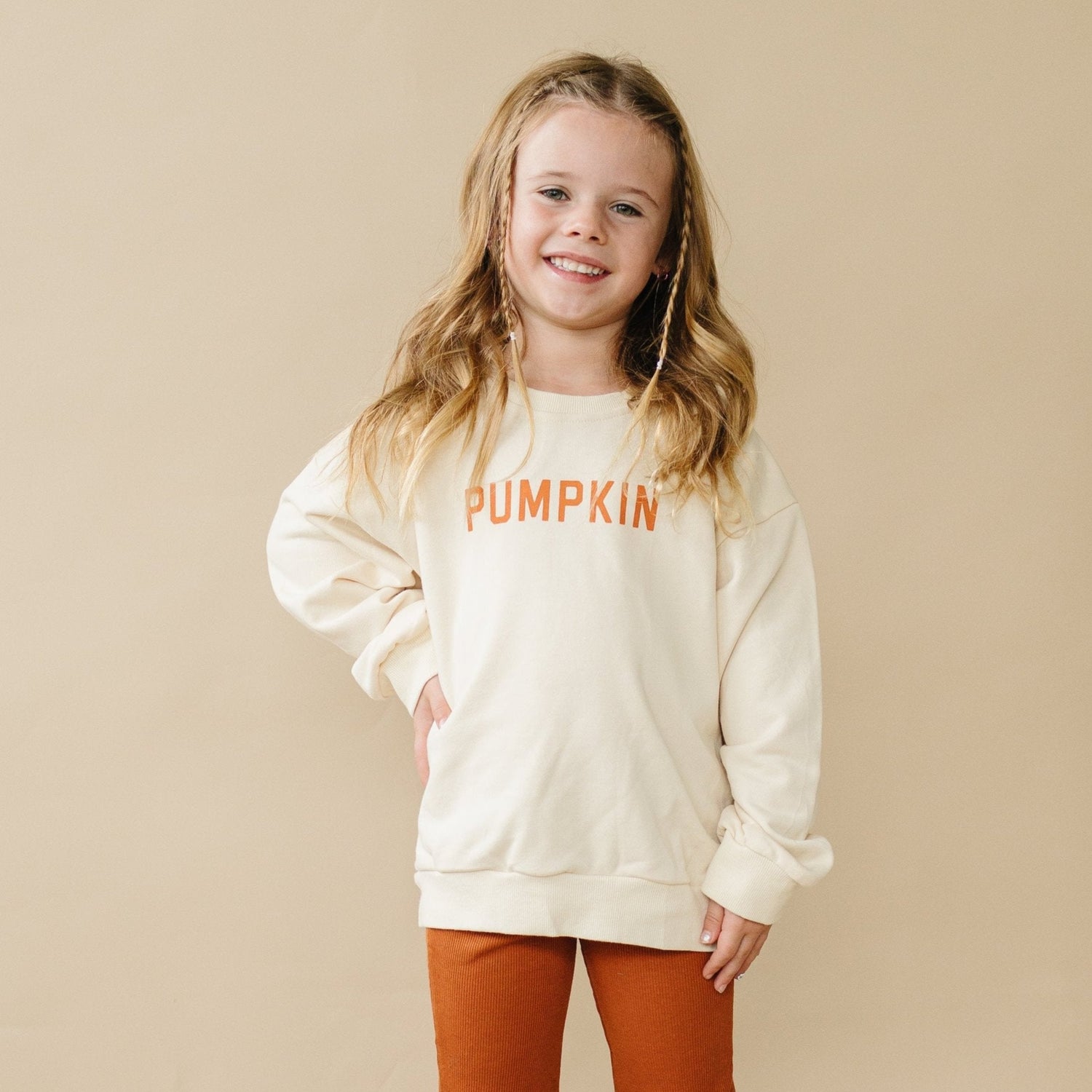 Cream crewneck sweatshirt with a pumpkin graphic on the front
