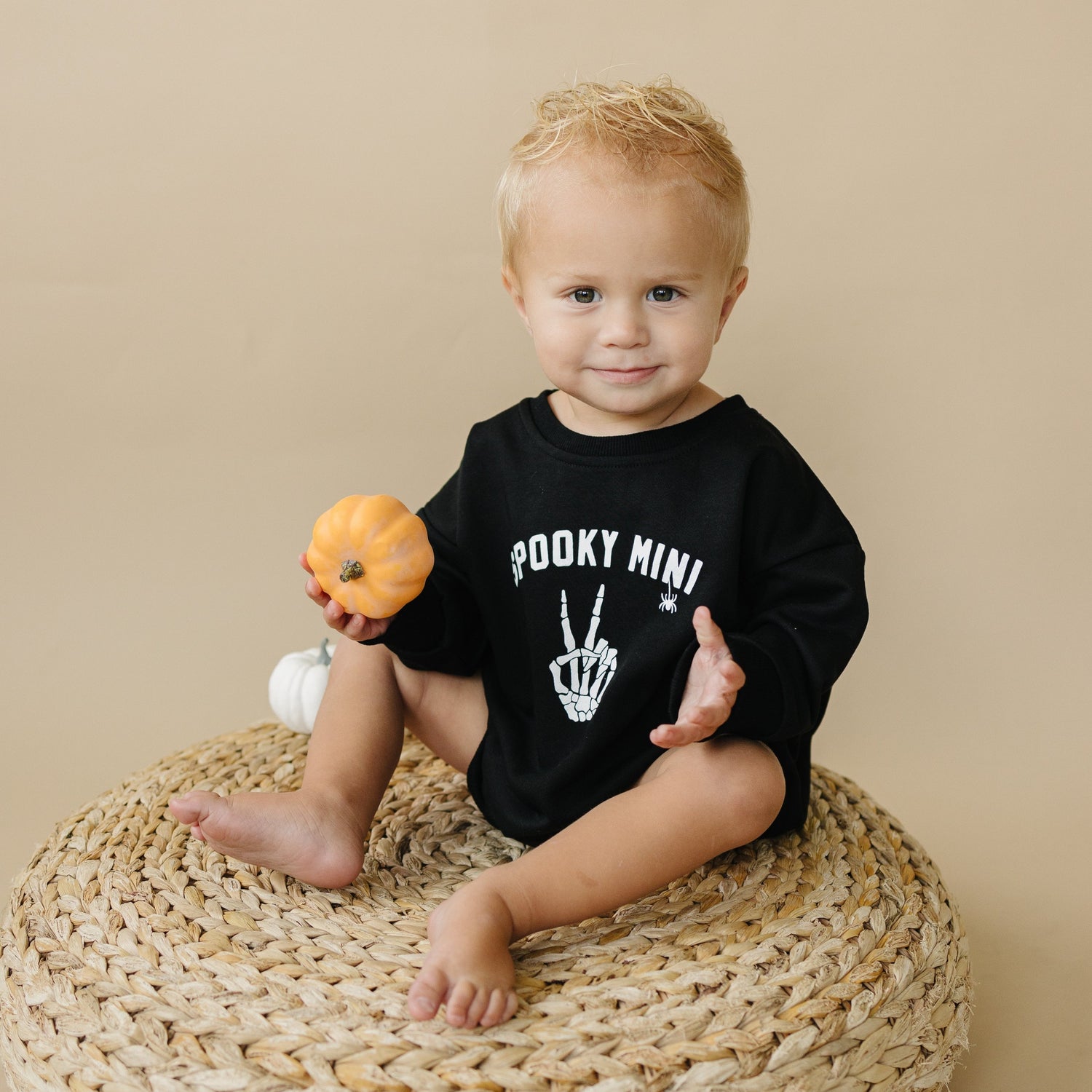 Oversized sweatshirt romper with a dancing skeletons graphic and snap closure at the crotch