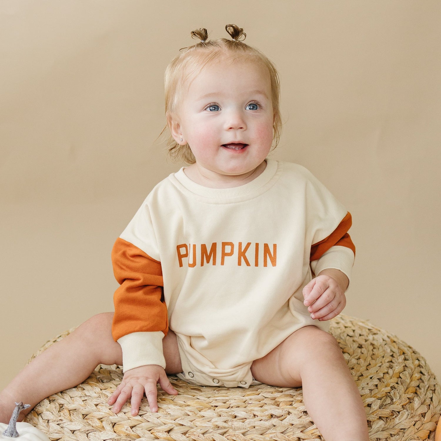 Colorblock sweatshirt romper with "Mama's Little Pumpkin" screenprinted graphic and snaps at the crotch