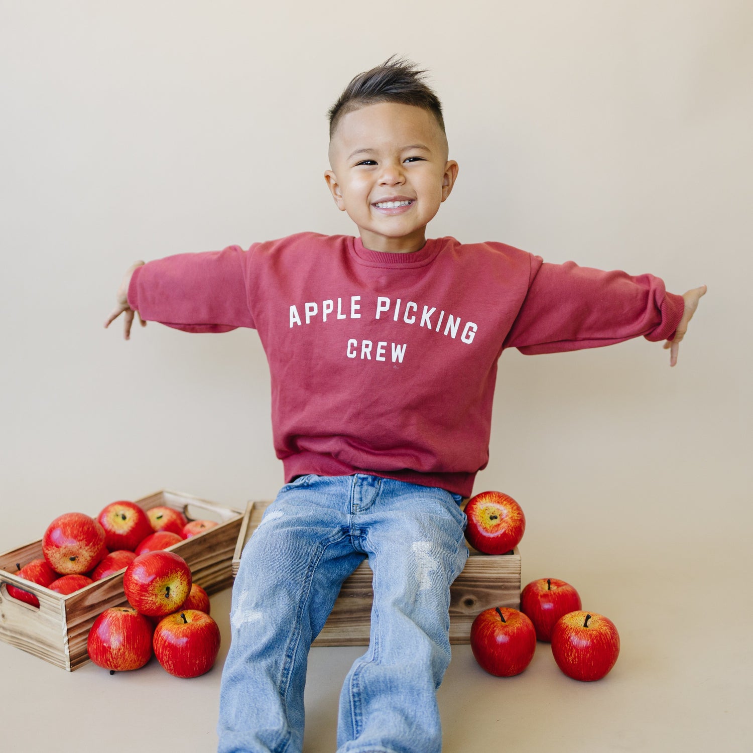 Crewneck sweatshirt with an apple picking crew graphic printed on the front