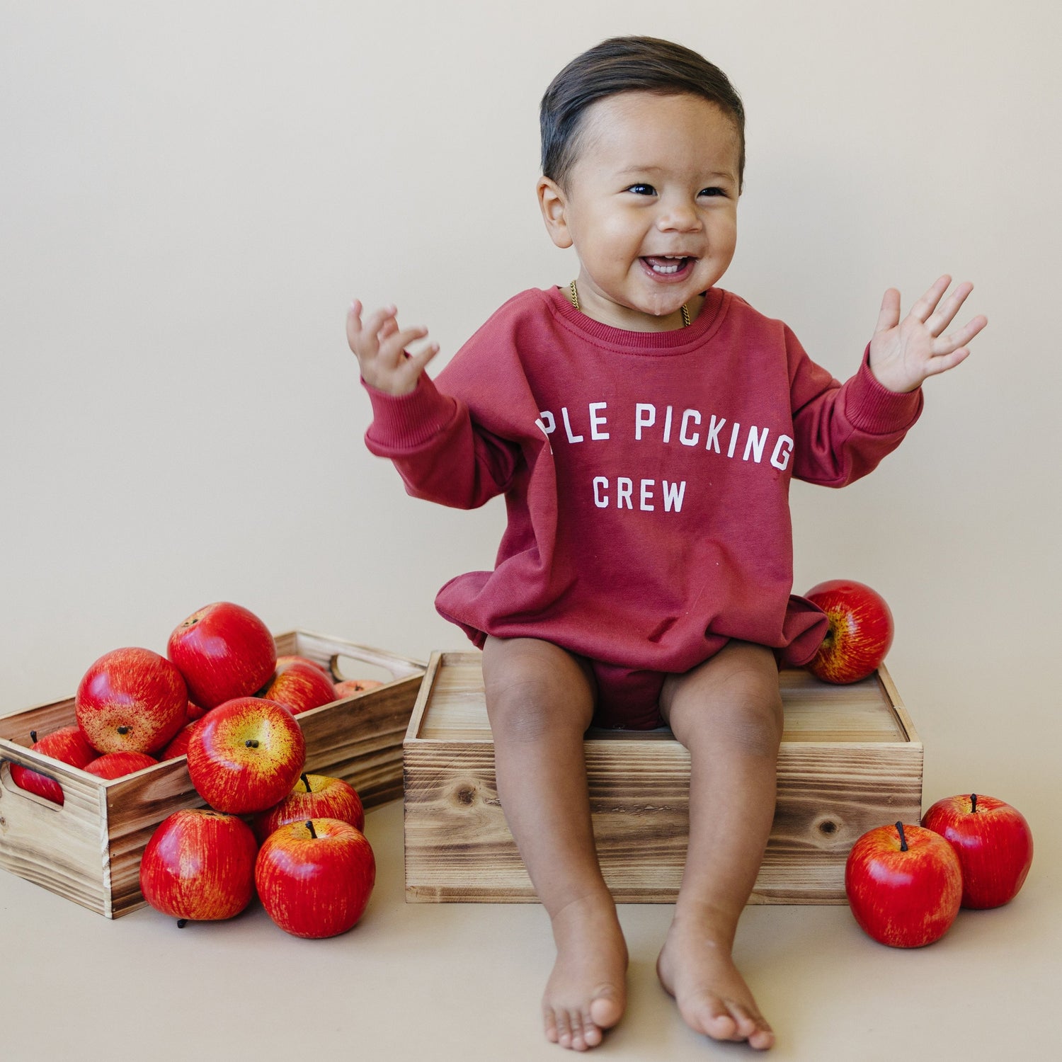 Oversized sweatshirt romper with Apple Picking Crew screenprinted fall design and snap crotch closure