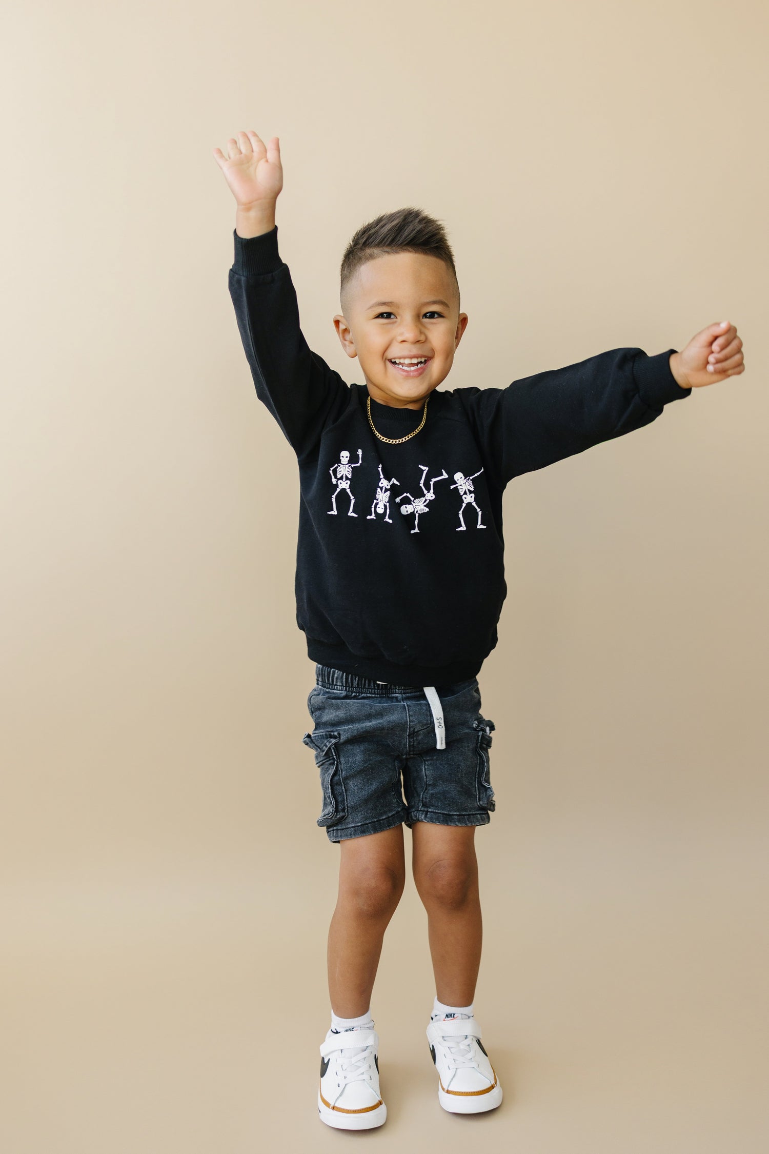 Crewneck sweatshirt with a screenprinted dancing skeletons Halloween design on the front