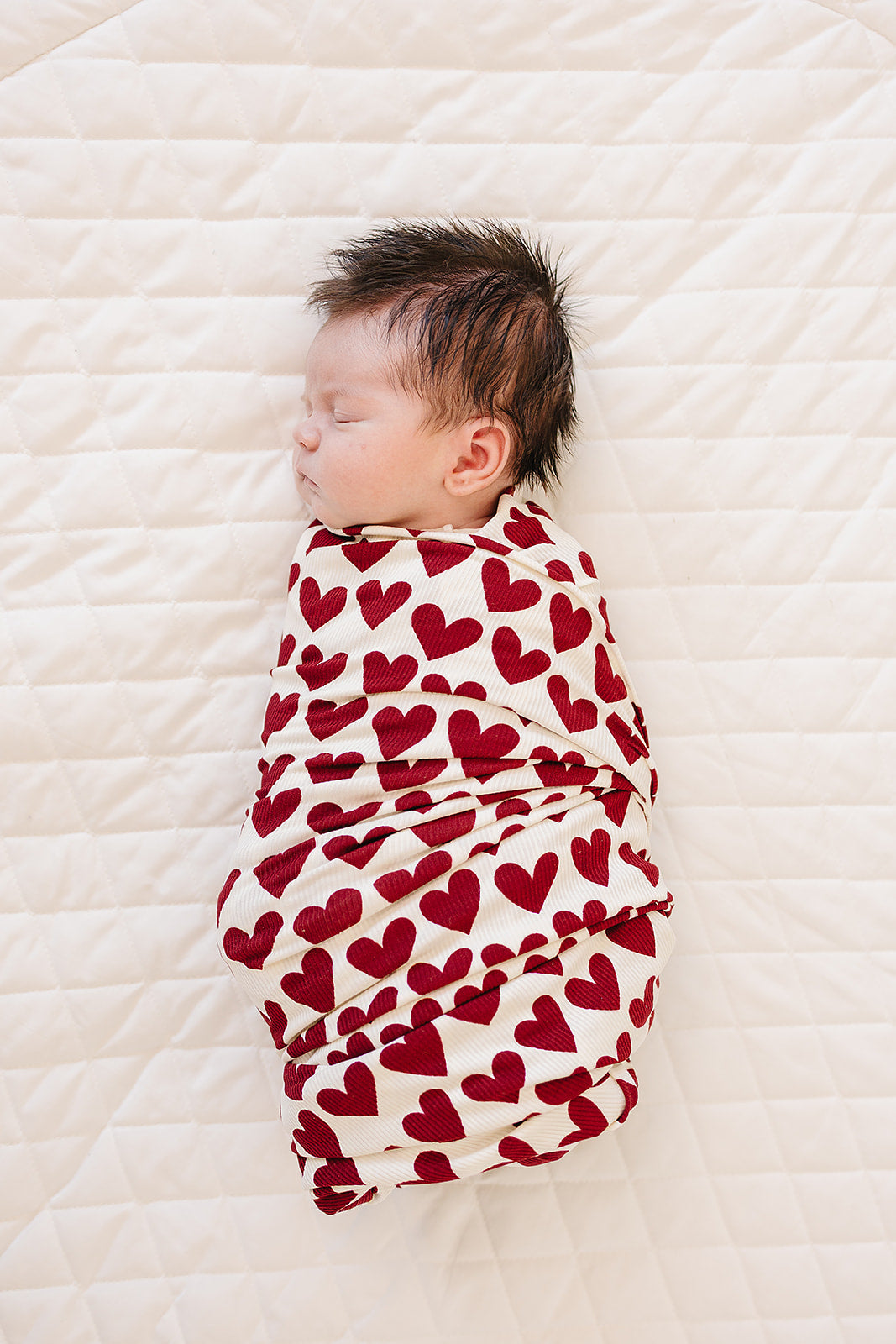 Mebie Baby organic bamboo stretch swaddle with ribbed texture and heart print.