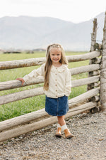 Cream Ruffle Knit Cardigan by Mebie Baby