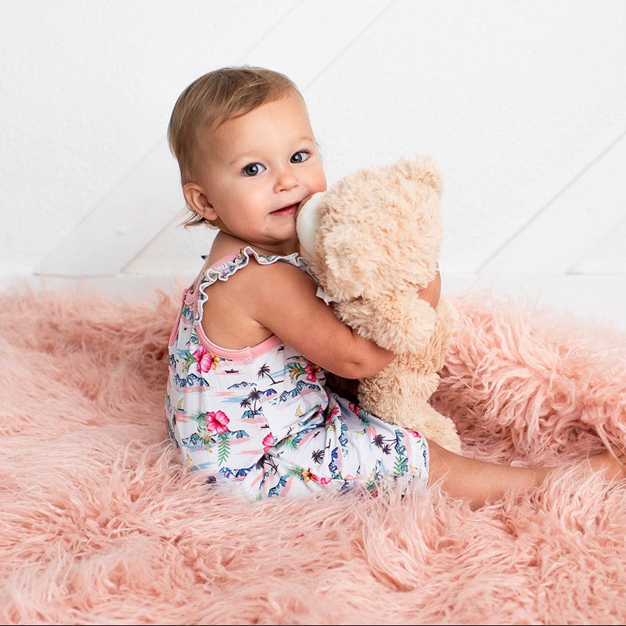 Baby bubble romper in Aloha print with flutter sleeves and snap closures along the legs
