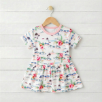 Short sleeve baby bodysuit dress in an Aloha print with a flared skirt and snaps at the bottom