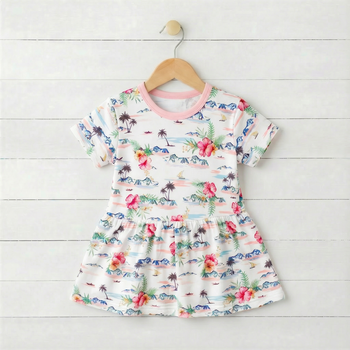 Short sleeve baby bodysuit dress in an Aloha print with a flared skirt and snaps at the bottom