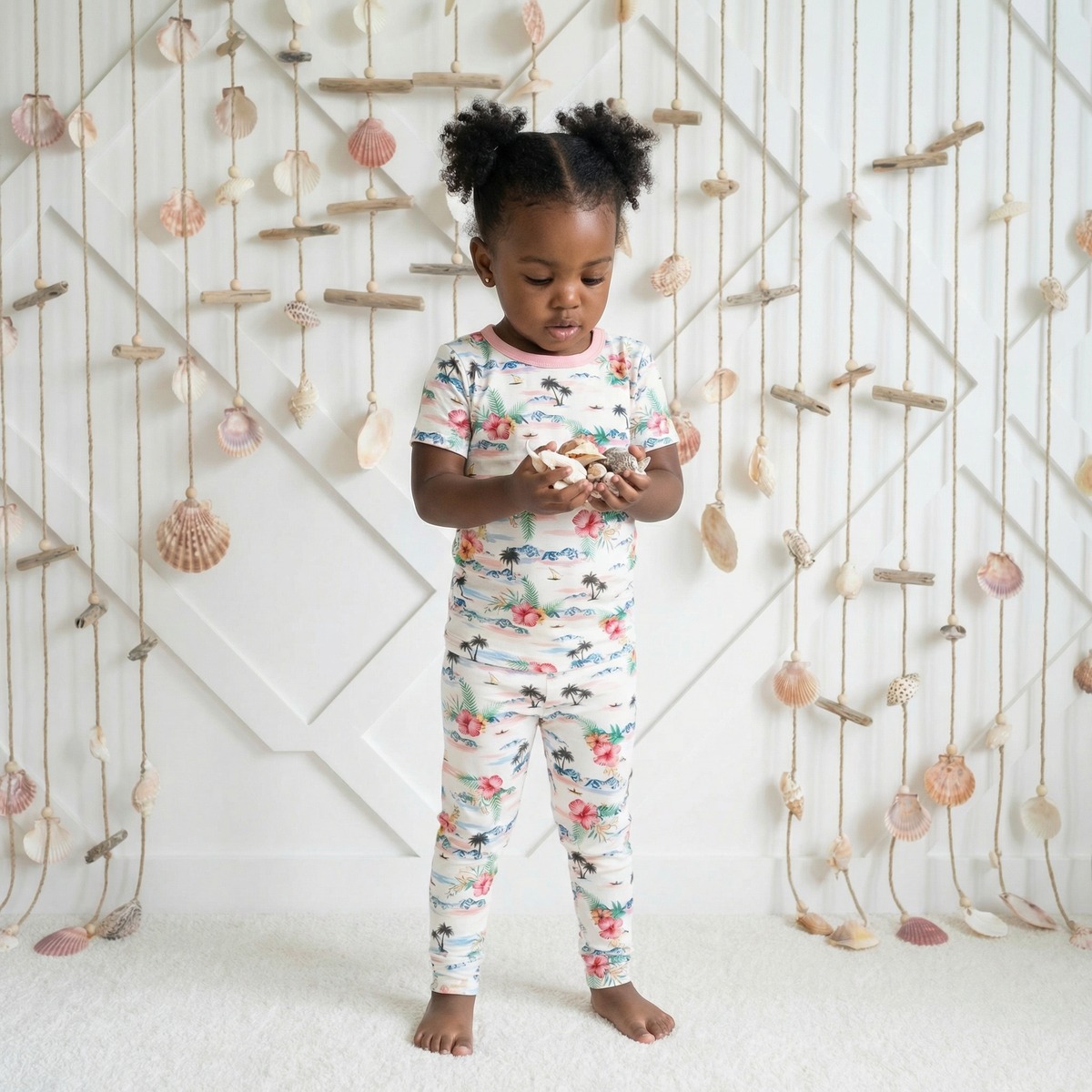 Two-piece pajama set with short sleeve top and long pants in an Aloha print