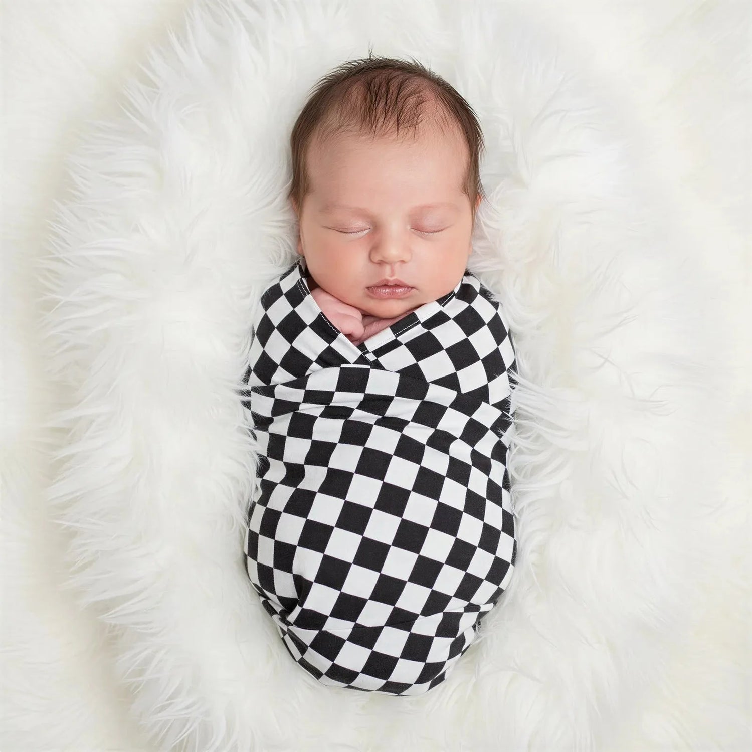 Charcoal and gray checked swaddle blanket laid flat with a gingham-style pattern