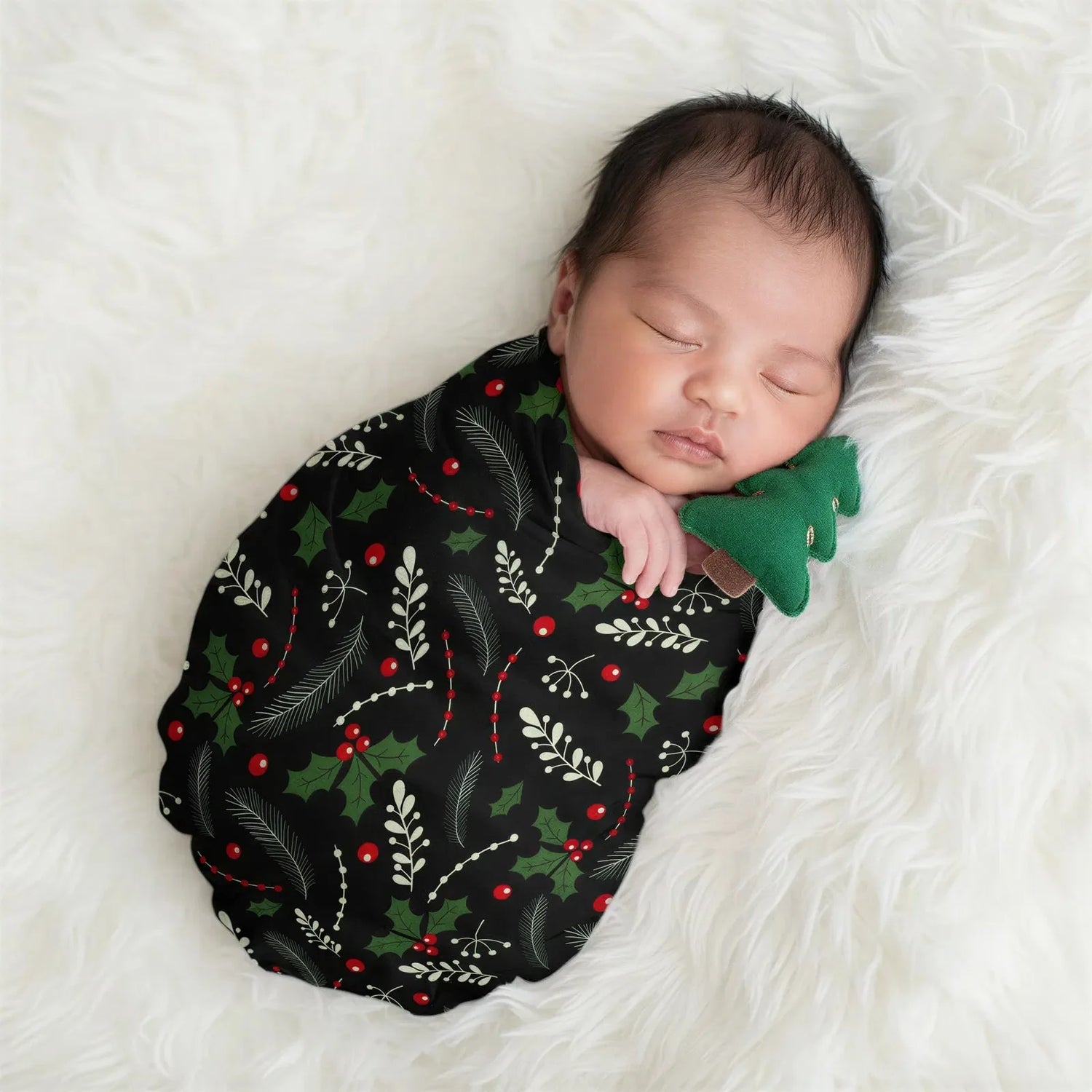 Holiday Nights swaddle blanket with a festive holiday print laid out square