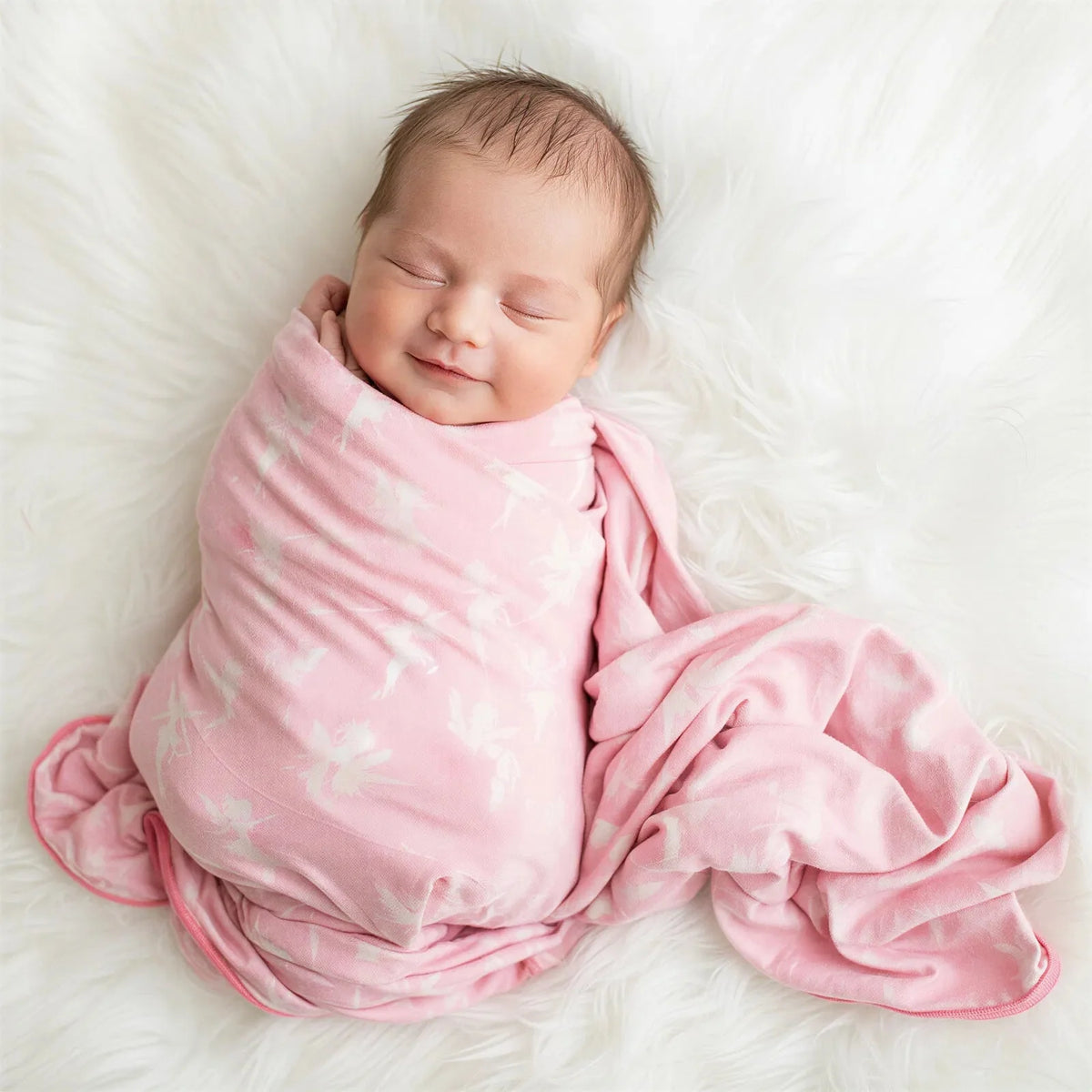 Swaddle blanket with a fairy print, spread flat to show the full square design and soft fabric.