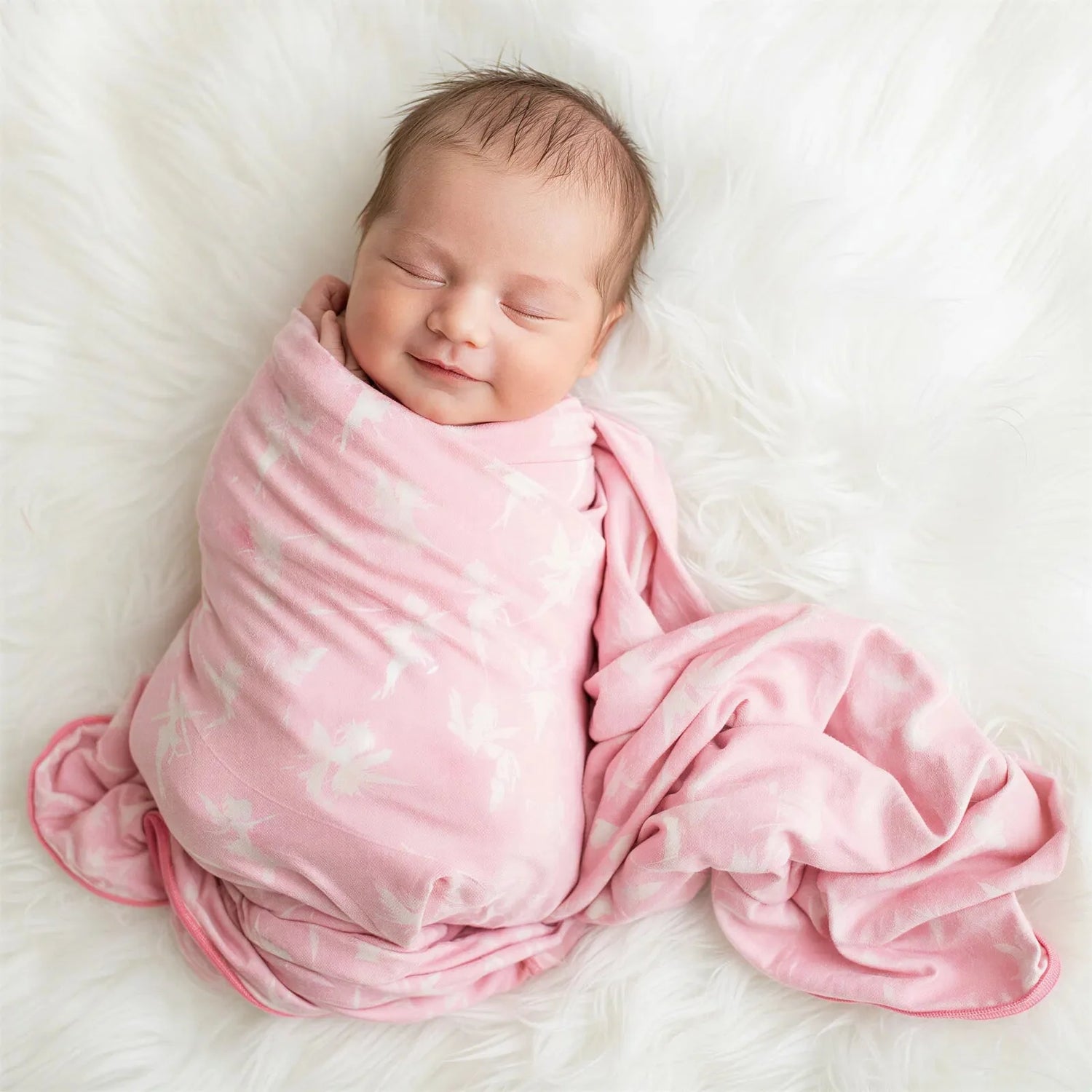 Swaddle blanket with a fairy print, spread flat to show the full square design and soft fabric.