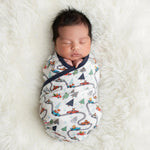 Baby swaddle blanket in a festive holiday print, spread out to show the pattern.