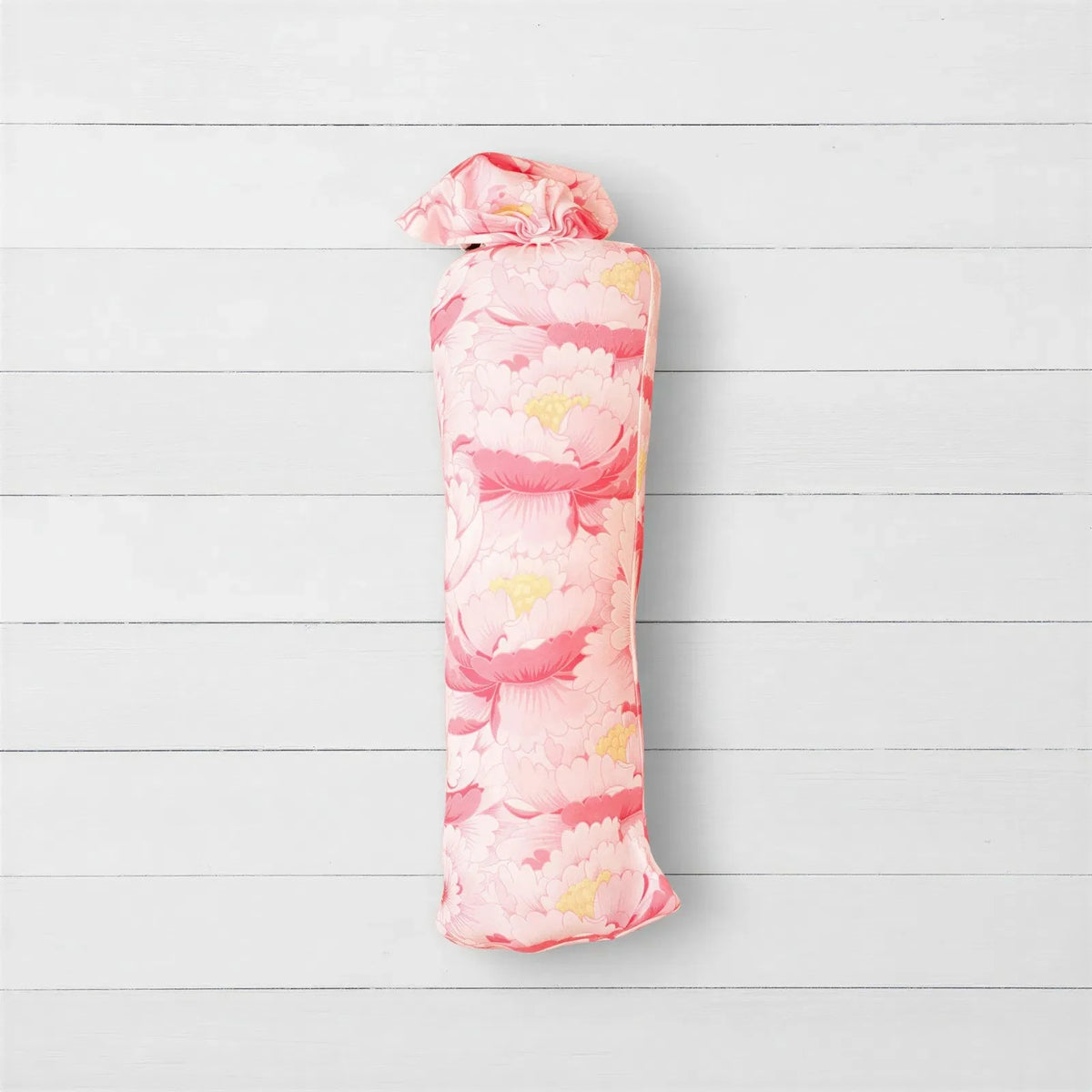 Blush pink swaddle blanket with a soft floral pattern, laid out square